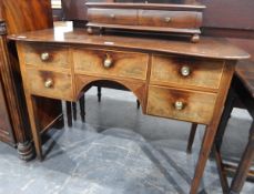 19th century mahogany dressing table, the shaped top over an arrangement of five drawers,