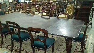 Early 19th century mahogany extending dining table of rectangular form with turned legs and brass