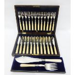 Set of 12 EPNS fish eaters in a wooden case and a pair of fish servers,