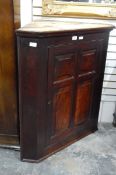 19th century mahogany corner cabinet with later restoration, panelled cupboard door,