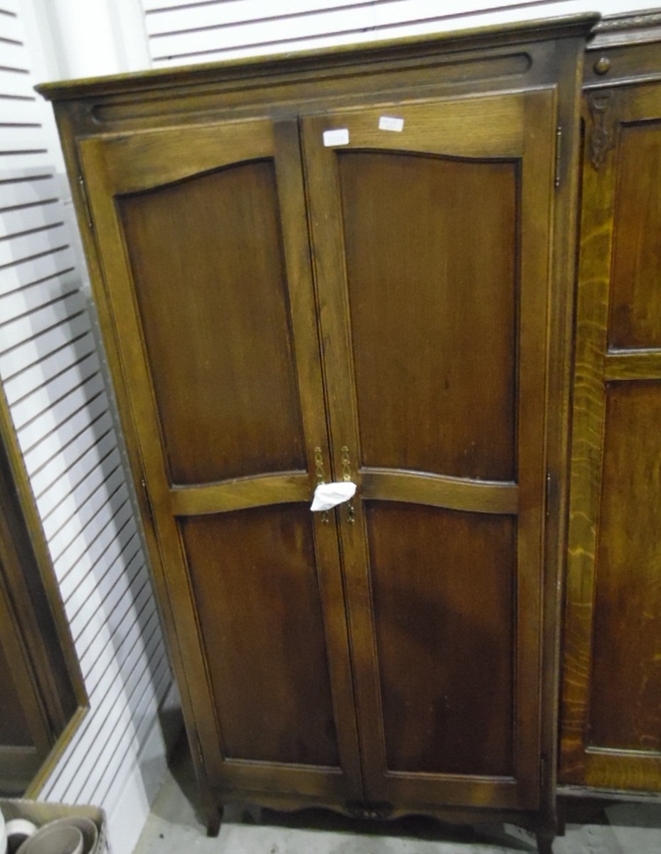 Oak two-door wardrobe with panelled doors,