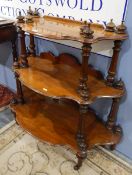 19th century carved mahogany three-tier whatnot, with turned finials, on turned legs and castors,