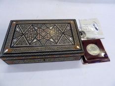 An inlaid ivory and mother of pearl wood games/backgammon box, containing various Jewish medallions,