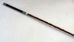 Wooden and metal mounted lunge whip with leather handle