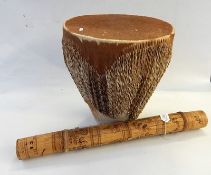African skin covered drum applied raffia to sides, 41cm high and a bamboo stringed instrument,