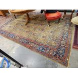 A Persian rug yellow ground floral design to centre, with red and blue borders,