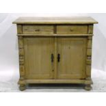 Pine side cupboard, the moulded edge top above two short drawers,