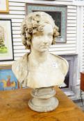 A plaster bust, female, with curled hair and a shawl around her shoulders,