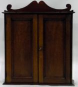 Late 19th century miniature mahogany cabinet, with shaped pediment,