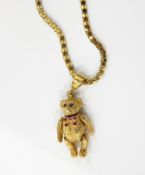 9ct gold teddy bear pendant, set with gems on a 9ct gold chain,