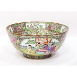 A large modern Chinese bowl decorated with panels of figures and flowers within profuse floral