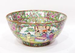 A large modern Chinese bowl decorated with panels of figures and flowers within profuse floral