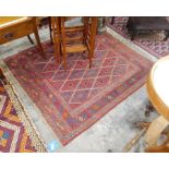 A Persian wool rug, red ground with medallion deign and geometric borders,
