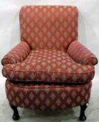 Deep armchair with pink patterned upholstery, loose cushion seat,
