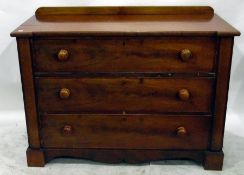 19th century mahogany chest of three long drawers, with wooden handles, shaped apron, on block feet,