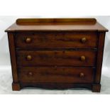 19th century mahogany chest of three long drawers, with wooden handles, shaped apron, on block feet,