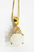 Gold-coloured pendant set with an oval white opal and surmounted by six brilliant cut diamonds,