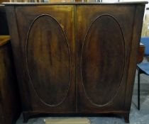 Georgian mahogany bookcase, the pair of oval panelled doors enclosing adjustable shelves,