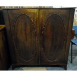 Georgian mahogany bookcase, the pair of oval panelled doors enclosing adjustable shelves,