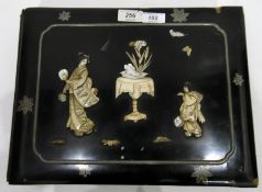 Japanese lacquered papier mache postcard album with applied bone and mother-of-pearl figure