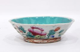 A Chinese pottery bowl of shallow lobed form, the exterior painted with flowers.