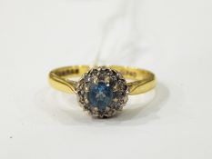 18ct gold and diamond cluster ring with central circular blue stone surrounded by a cluster of tiny