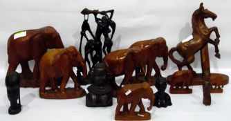 Collection of carved wooden elephants of varying sizes,