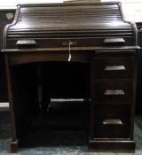 Early 20th century oak roll-top desk, the interior fitted with small drawers and pigeonholes,