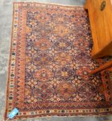 A Persian medallion design rug in blue and red, with cream border,