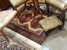 Baluchi wool rug having two octagonal guls, on an ivory field and four geometric borders,