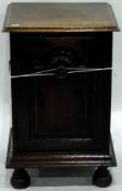 Oak coal box, the hinged door opening to reveal metal lined interior, raised on bun feet,
