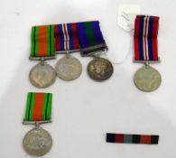 George VI group of three medals and another