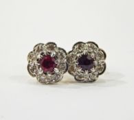 Pair of 18ct gold, ruby and diamond flower-shaped earrings, the centre ruby 4mm diameter,