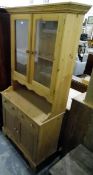 Contemporary pine kitchen dresser, the pair of glazed panelled doors enclosing shelf,