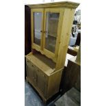 Contemporary pine kitchen dresser, the pair of glazed panelled doors enclosing shelf,