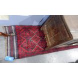 A Persian wool runner, blue ground with red medallion design,