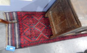 A Persian wool runner, blue ground with red medallion design,