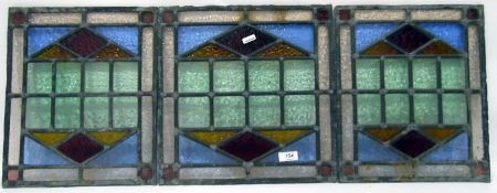 Three panels of leaded and stained glass,