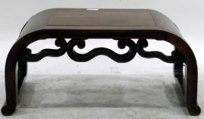 Chinese hardwood stool of curved form, with scroll brackets and feet,