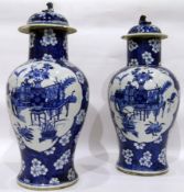 Pair of Chinese blue and white inverse baluster vases and covers with dog of Fo finials,