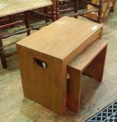 An Ercol style nest of four tables, with handle holds to the sides , 51 x 30 cms approx .