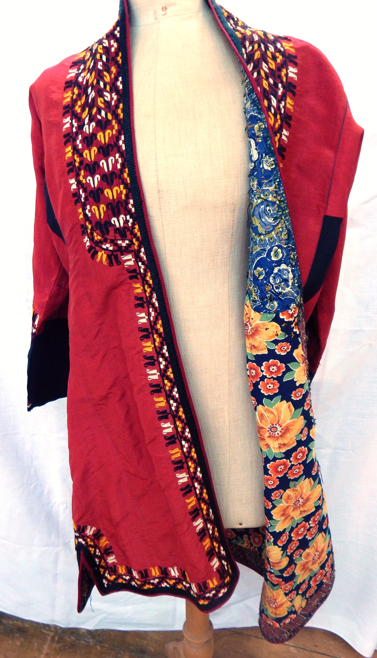 20th century Turkman robe in red adras with floral cotton linings and elaborate bands of black,