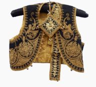 A child's waistcoat in black felt, possibly Turkish, heavily embroidered in gold thread ,