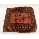 Middle Eastern saddle bag rug, red ground with central tree design and Aztec striped borders,