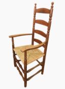 Pair of Ernest Gimson yew rush-seated armchairs made by Edward Gardiner each ladderback with turned