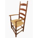 Pair of Ernest Gimson yew rush-seated armchairs made by Edward Gardiner each ladderback with turned