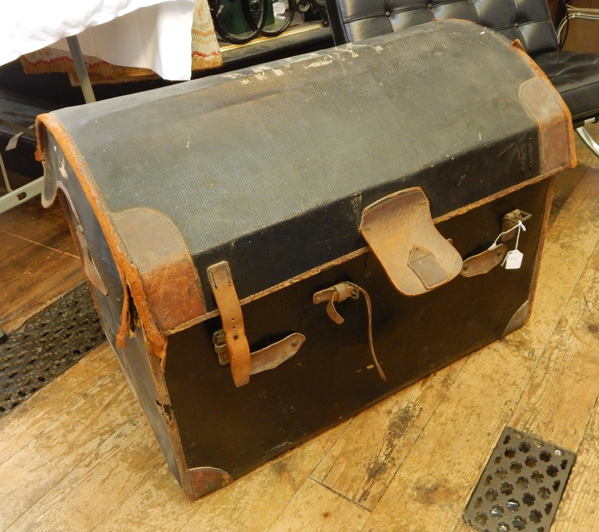 Domed leather travelling trunk with fitted tray, leather trimmed, but worn,