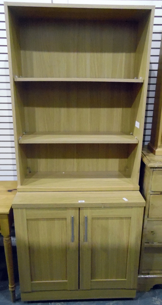 Modern pine-effect three-tier bookcase and a matching side cupboard,