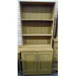Modern pine-effect three-tier bookcase and a matching side cupboard,