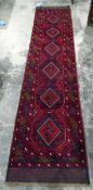 Meshwani wool runner with six octagonal guls to the cherry red field and diagonal borders,